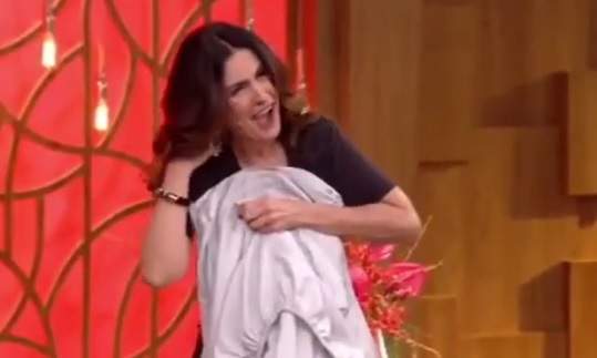 Fátima Bernardes trava o pescoço ao tentar dobrar lençol em programa